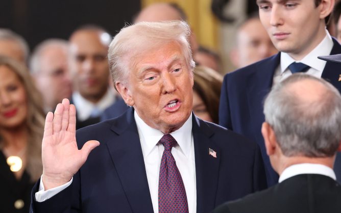 Man with right hand raised