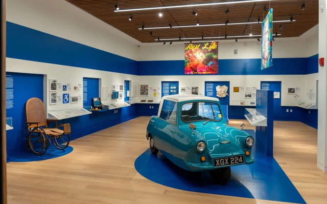 Museum exhibit with blue vehicle at center