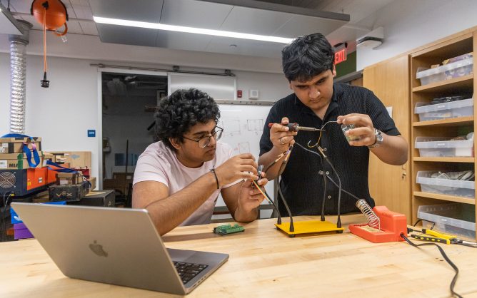 Two teens tinker in lab