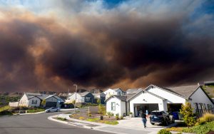 Wildfire smoke seen behind homes