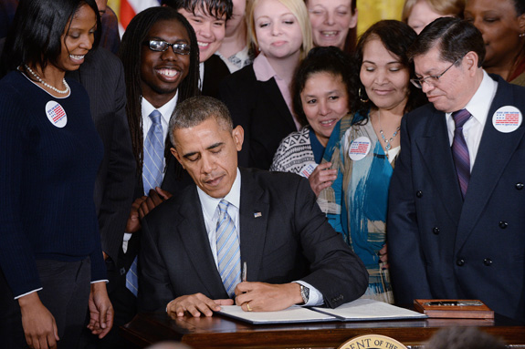 President Barack Obama signs an executive order requiring that workers employed under federal contracts -- including those with disabilities -- be paid at least $10.10 per hour. (Olivier Douliery/Abaca Press/MCT)