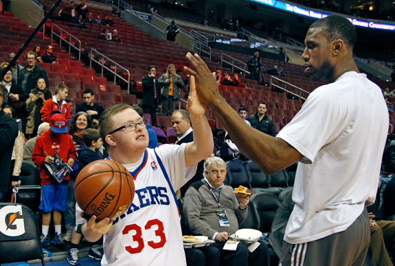 Kevin Grow, left, gave a high-five to Thaddeus Young of the Philadelphia 76ers before a game earlier this month when the teen with Down syndrome was honored by the NBA franchise. Next month, Grow will play with the Harlem Globetrotters. (Ron Cortes/Philadelphia Inquirer/MCT)