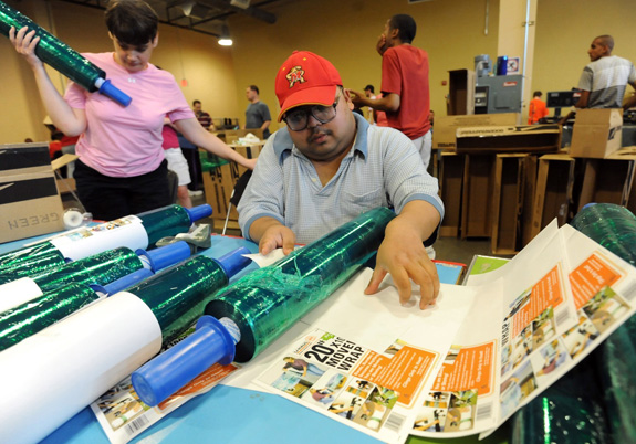 Cindy Rankin, 43, left, and Sanjay Singh, 31, put labels on rolls of mover's stretch wrap in the Opportunity Builders, Inc. warehouse in Millersville, Md. where both receive less than minimum wage for their work. A bill moving through Congress would put limits on young people with disabilities entering such jobs. (Kim Hairston/Baltimore Sun/MCT)