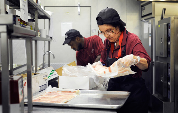 Cindy Iames, right, and Damien Ross make less than minimum wage working at Chimes Cafe in Baltimore. (Christopher T. Assaf/Baltimore Sun/MCT)