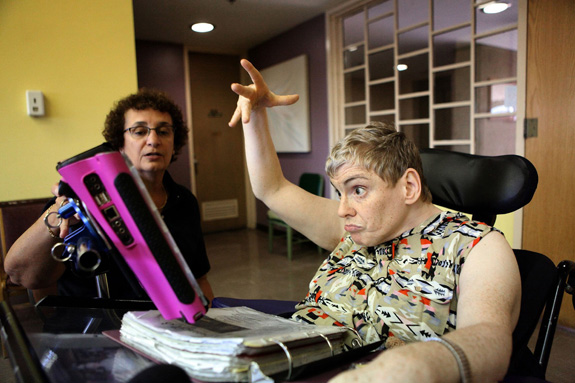 Wendy English, a longtime resident of the Woodbridge Developmental Center in New Jersey, uses a chart and iPad to communicate. She expected to live at the center for the rest of her life, but with the facility set to close, English must move. (Thomas E. Franklin/The Record/MCT)