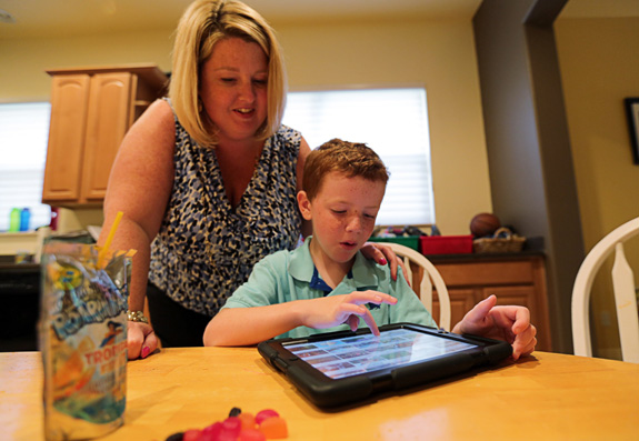 Lindsay Graham, left, watches son J.D., who has autism, at the family's Orlando, Fla. home. The number of children with neurodevelopmental or mental health conditions jumped 21 percent between 2001 and 2011, likely due in part to increasing autism prevalence, researchers say. (Ricardo Ramirez Buxeda/Orlando Sentinel/MCT)