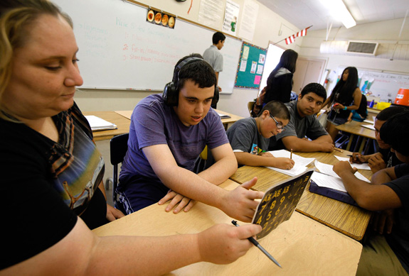 Ido Kedar, center, who has autism, works with Anna Page during a class at Canoga Park High School in Canoga Park, Calif. The NIMH is funding new studies to identify services to help those with autism transition from high school and during other stages of life. (Genaro Molina/Los Angeles Times/MCT)