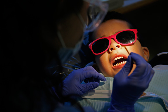 Dentists often rely on restraint and sedation to treat kids with disabilities, but with the right approach, these children are learning the skills to be treated just like other patients. (Jose M. Osorio/Chicago Tribune/MCT)