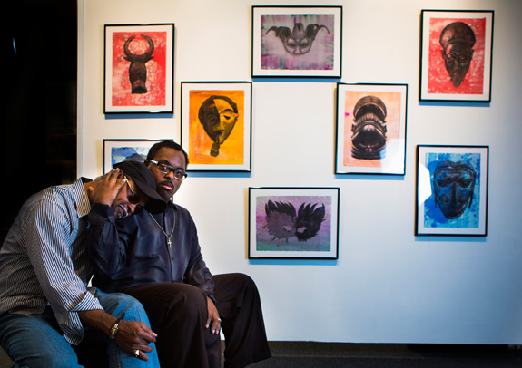 Ezra Roy, 26, holds Alvin Roy, who not only has been his parent but also his art teacher and mutual source of inspiration. Ezra graduated from Texas Southern University with honors over the weekend, earning a bachelor's degree in arts. His work has been exhibited at the Museum of Fine Arts Houston and at Houston City Hall. (Marie D. De Jesus/Houston Chronicle/TNS)